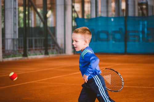 Boy playing red tennis