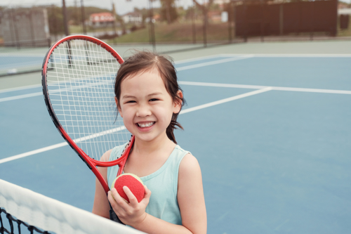 Girl with ball and racket