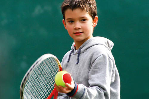 Kid with red ball tennis racket